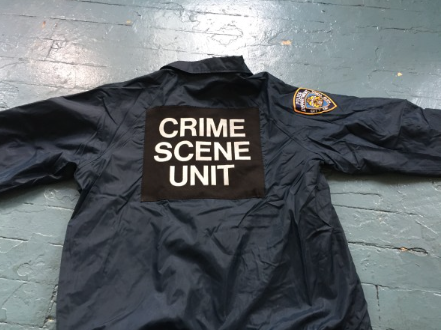 Navy blue NYPD Crime Scene Unit windbreaker jacket with large block lettering on back and shoulder patch