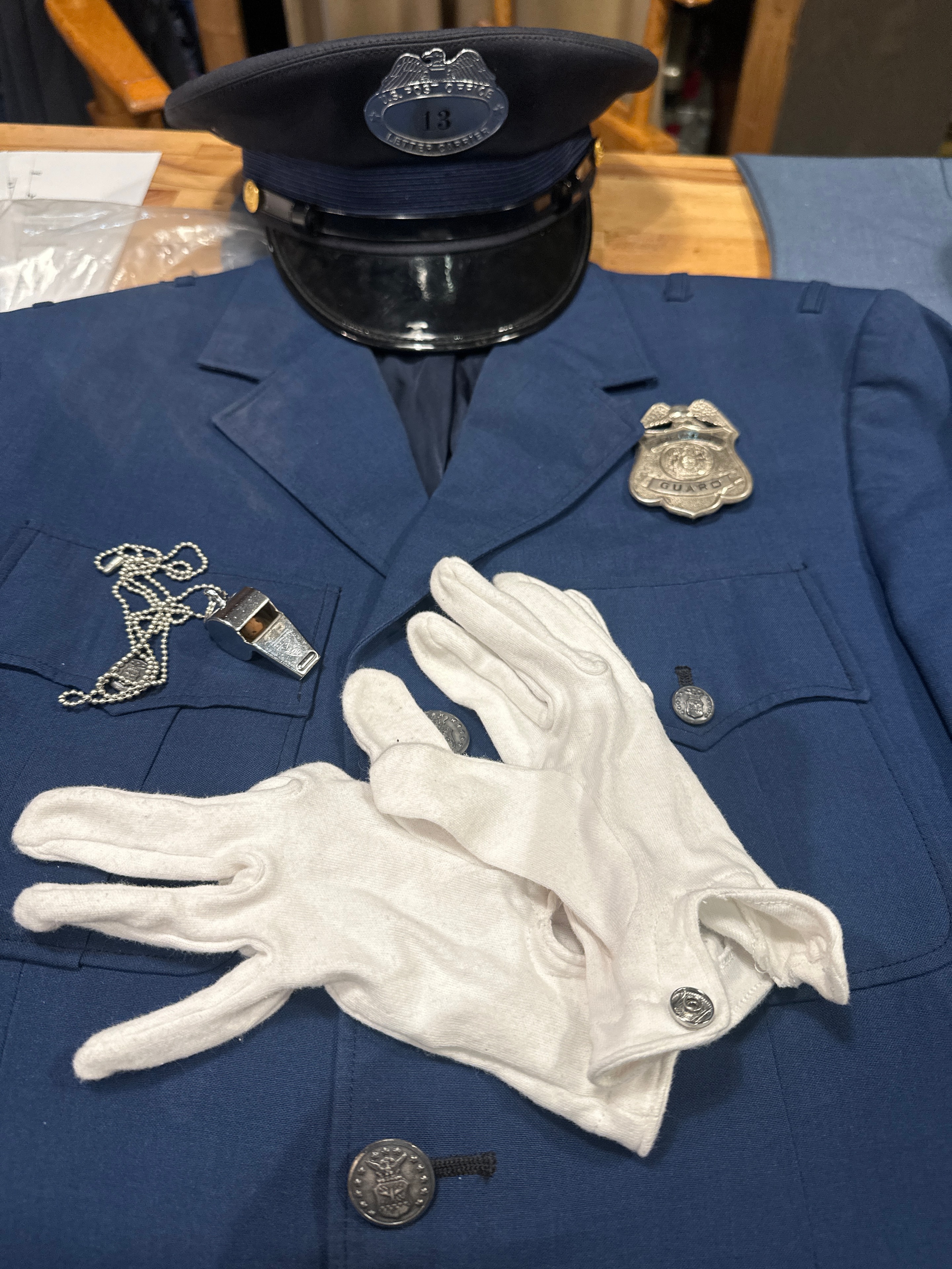 1950s intersection crossing guard uniform — navy blue jacket with silver badge, officer cap, white gloves, and whistle