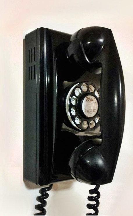 Vintage black wall-mounted rotary telephone with handset cradle