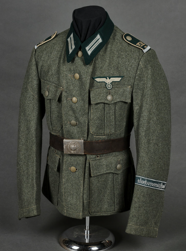 German Army wool field uniform tunic with eagle insignia and leather belt on mannequin