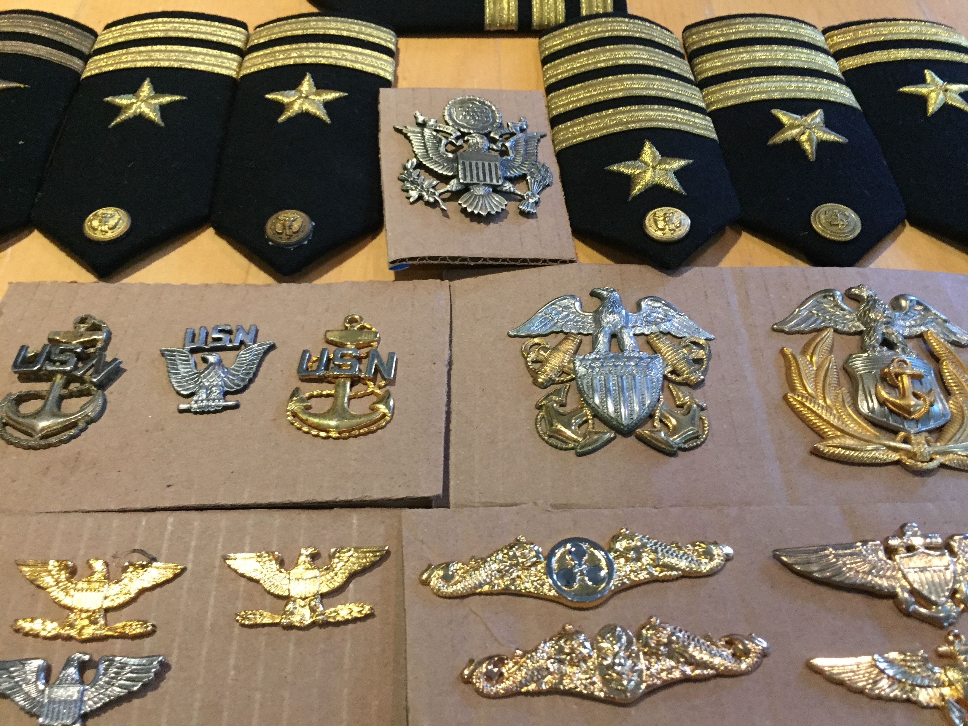 US Navy shoulder boards, USN anchor insignia, eagle cap badges, aviator wings, and submarine warfare devices