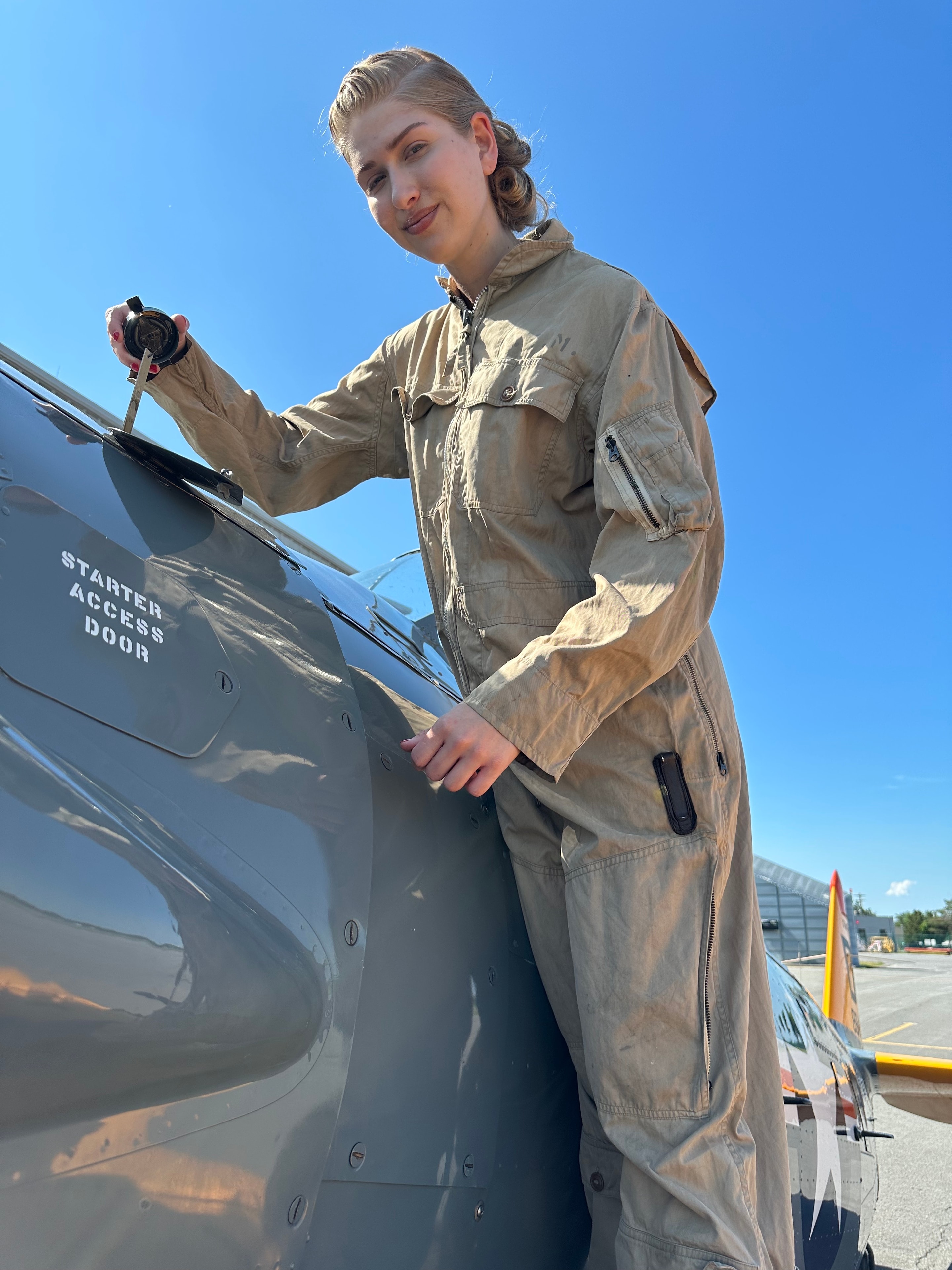 WWII Women's mechanic coveralls — khaki tan one-piece flight suit with zip front and chest pockets